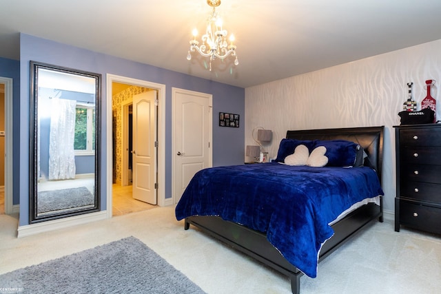 bedroom featuring an inviting chandelier and light colored carpet