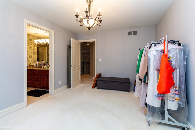 interior space with an inviting chandelier and light carpet