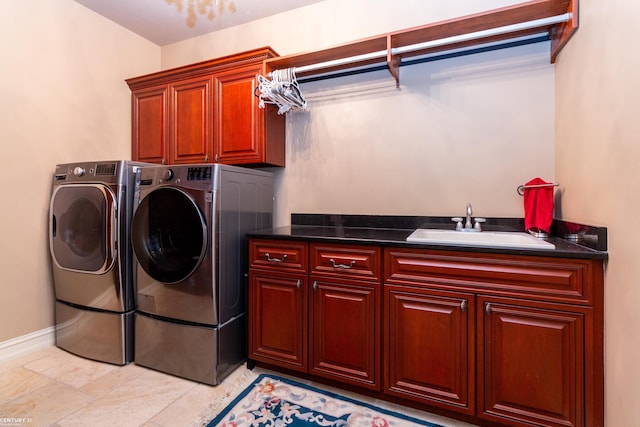 clothes washing area featuring separate washer and dryer, cabinets, and sink