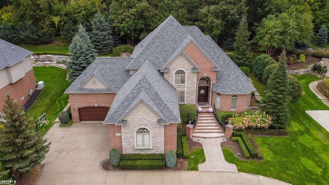 view of front of house featuring a garage and a front lawn