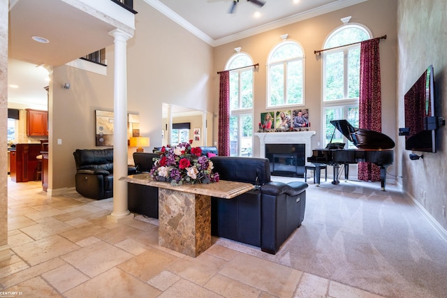 living room with light carpet, a high ceiling, decorative columns, and crown molding