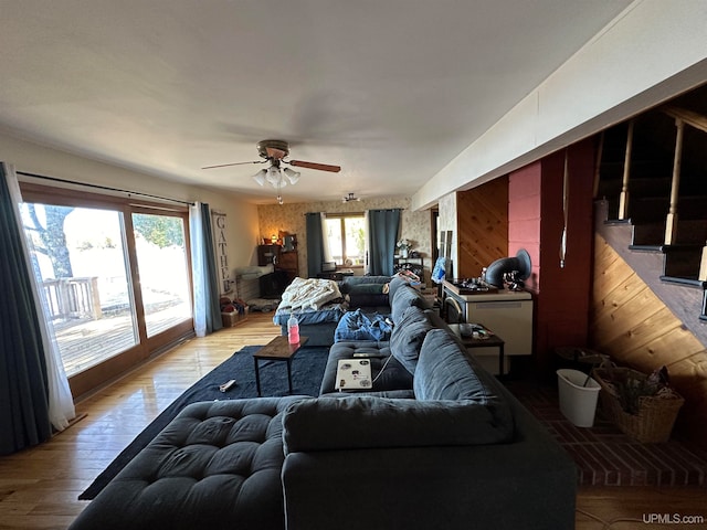 living room with ceiling fan and light hardwood / wood-style flooring