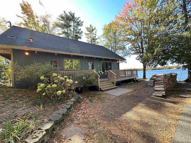 view of front of property with a deck with water view