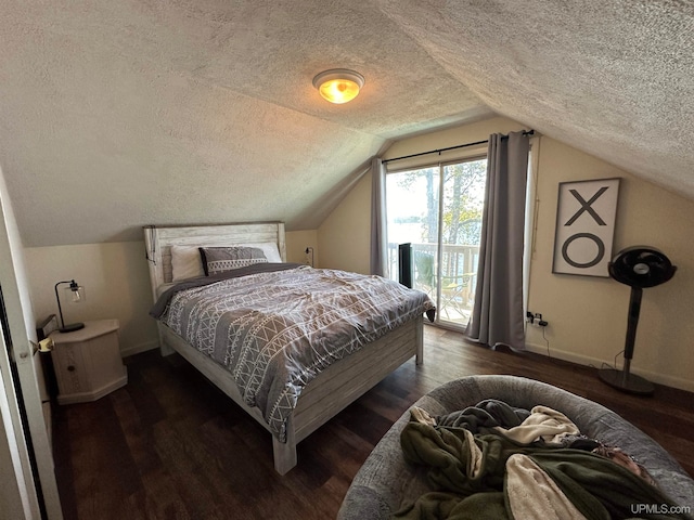 bedroom featuring a textured ceiling, lofted ceiling, and dark hardwood / wood-style floors