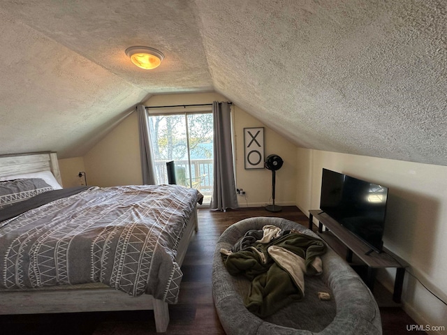 bedroom featuring access to outside, a textured ceiling, lofted ceiling, and dark hardwood / wood-style floors