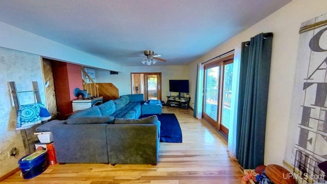 living room with ceiling fan and light wood-type flooring