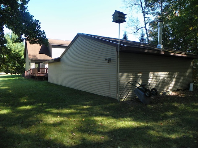 view of home's exterior featuring a lawn and a deck