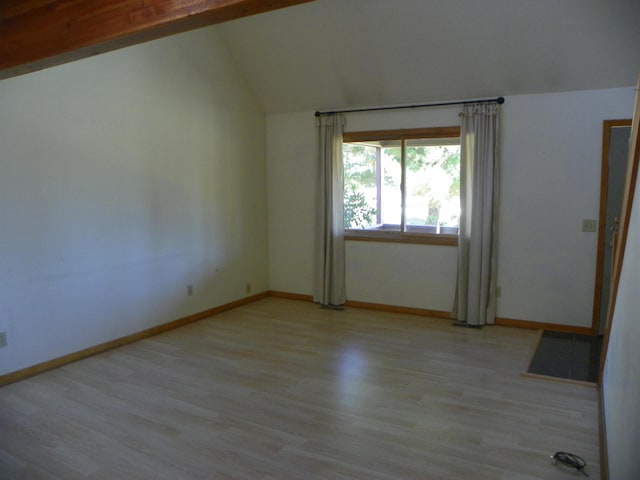 unfurnished room featuring light hardwood / wood-style flooring and vaulted ceiling