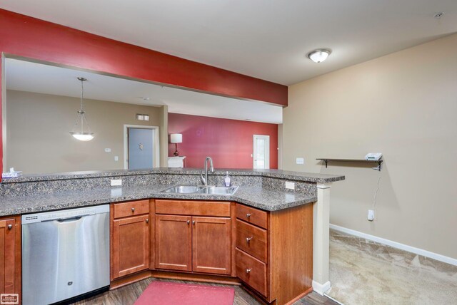 kitchen featuring pendant lighting, sink, carpet floors, light stone countertops, and stainless steel dishwasher