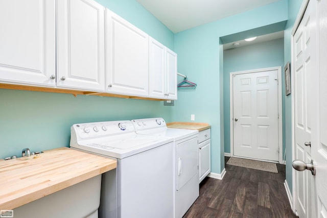 washroom with separate washer and dryer, dark hardwood / wood-style floors, and cabinets