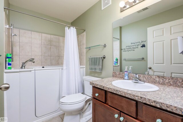 bathroom with tile patterned flooring, vanity, and toilet