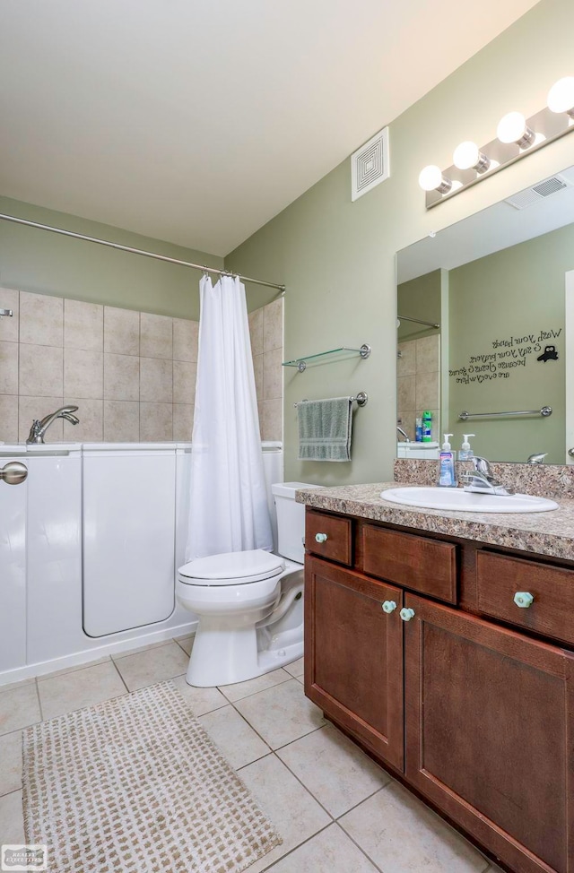 full bathroom with tile patterned flooring, vanity, toilet, and shower / bath combo with shower curtain