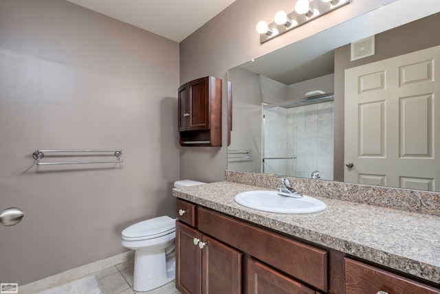 bathroom featuring walk in shower, vanity, toilet, and tile patterned floors