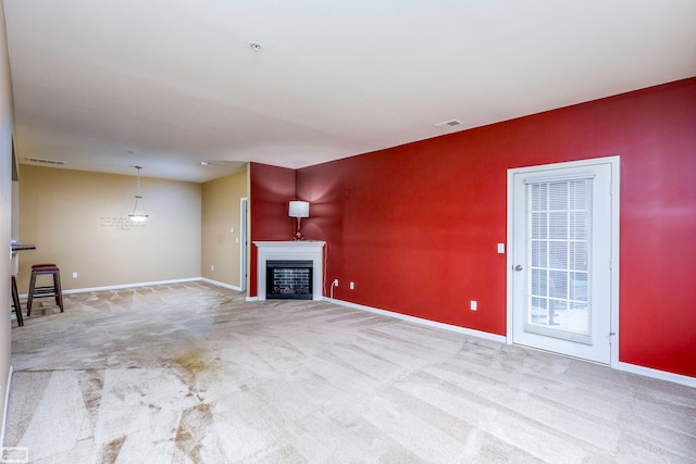 unfurnished living room featuring carpet