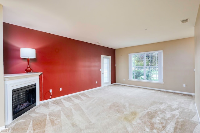 unfurnished living room featuring light colored carpet