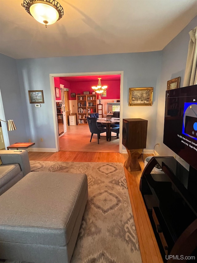 living room featuring wood-type flooring and a chandelier