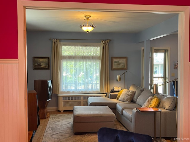 living room with radiator and light wood-type flooring