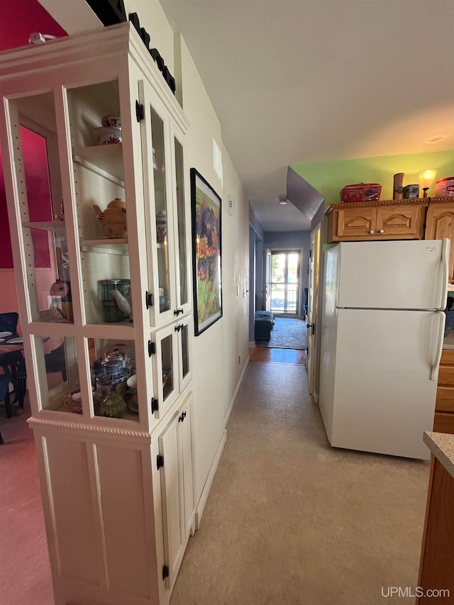 hallway featuring light colored carpet