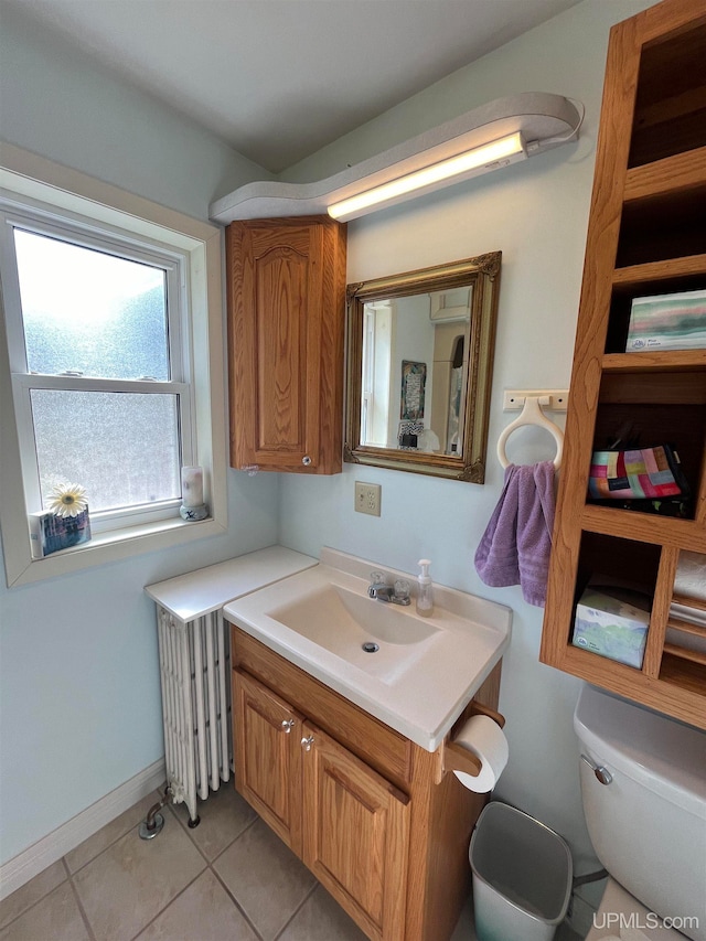 bathroom featuring toilet, vanity, and tile patterned floors