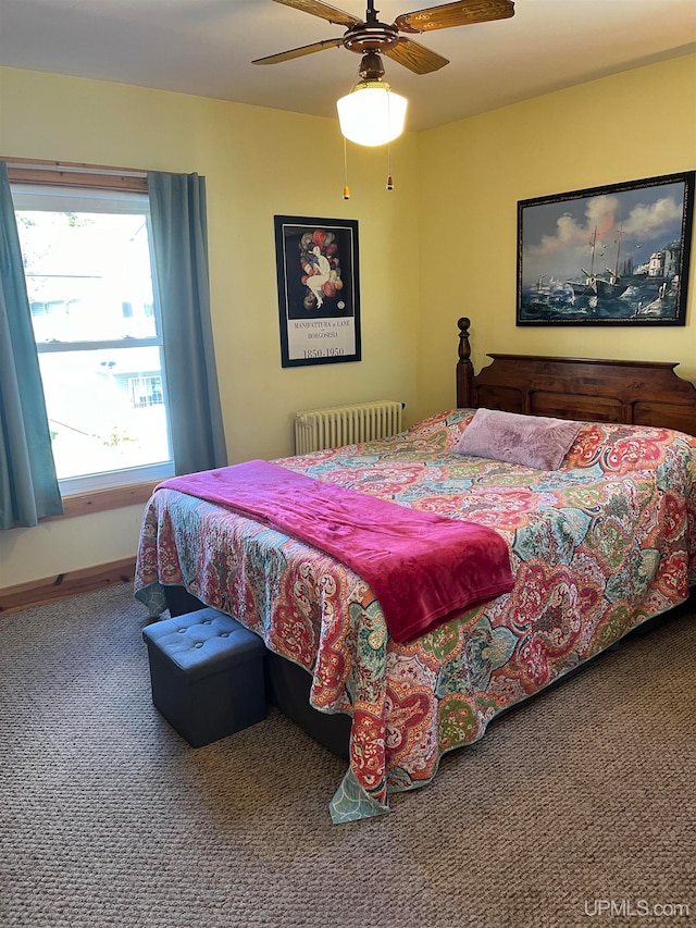 carpeted bedroom featuring radiator heating unit and ceiling fan