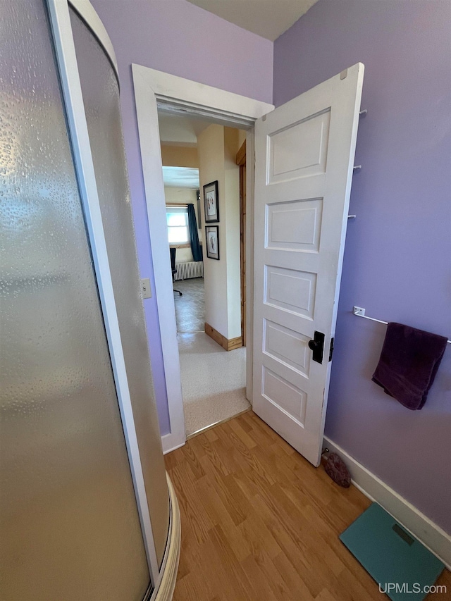 corridor with light hardwood / wood-style flooring