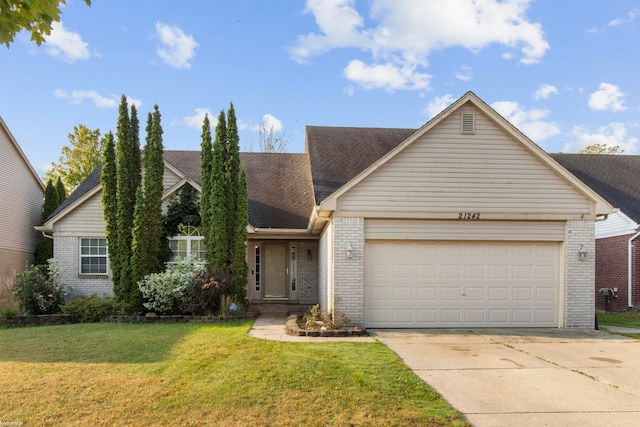 ranch-style house featuring a front lawn and a garage