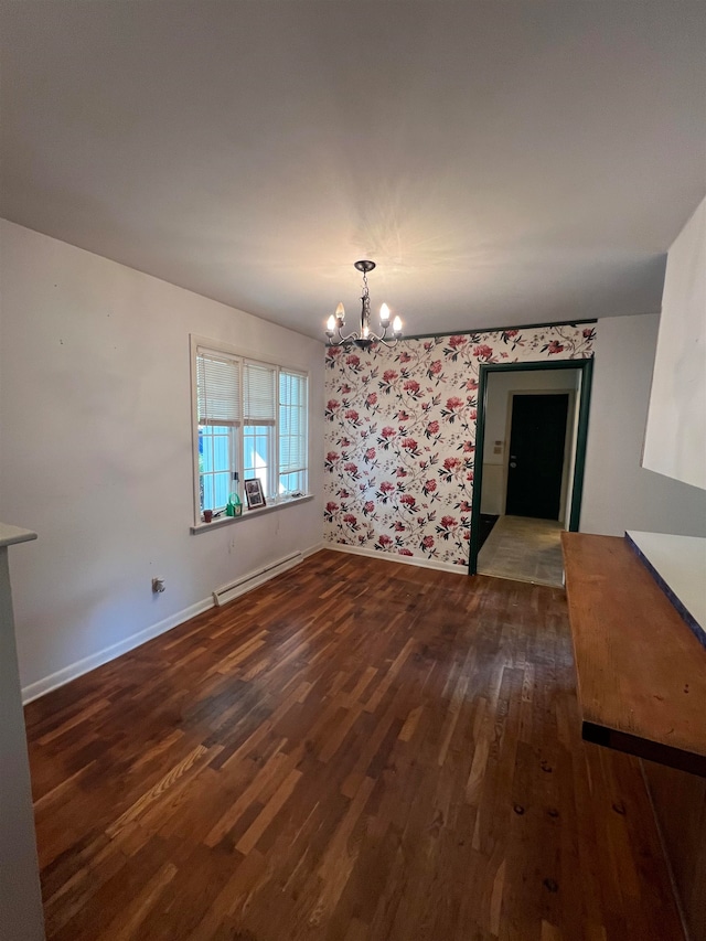 interior space featuring dark hardwood / wood-style floors, a chandelier, and a baseboard heating unit