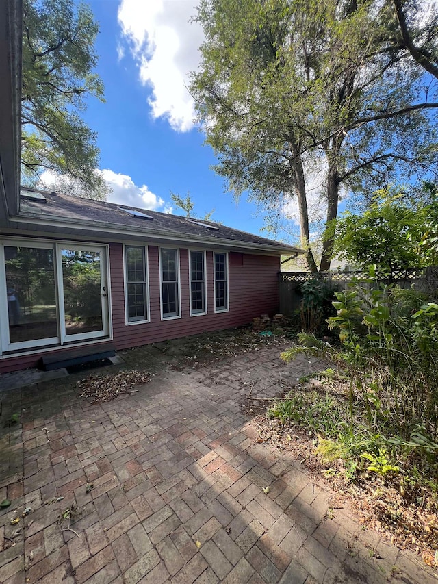 view of property exterior with a patio