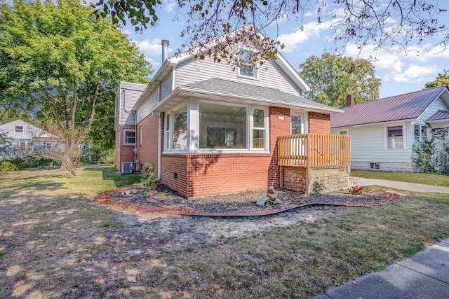 bungalow-style home featuring a deck and a front lawn