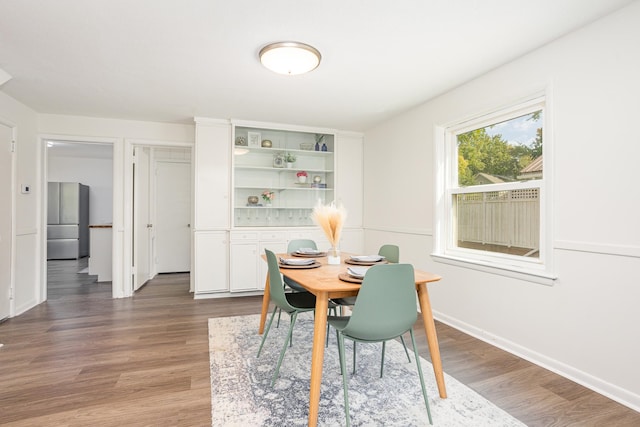 dining area with dark hardwood / wood-style flooring