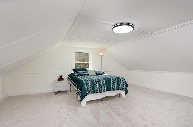 bedroom with carpet floors and lofted ceiling