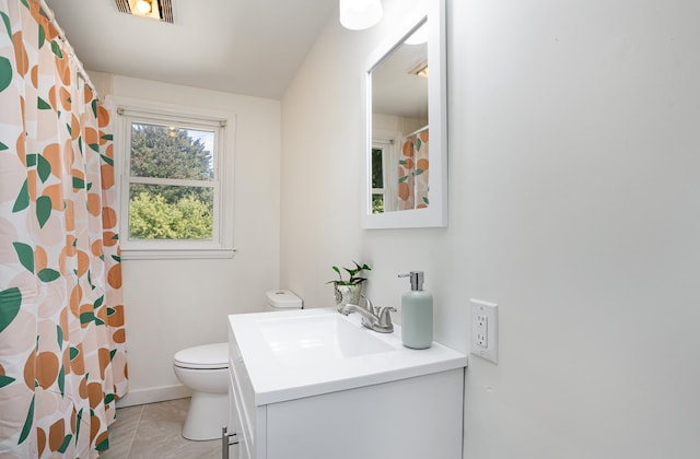 bathroom featuring curtained shower, vanity, toilet, and tile patterned floors