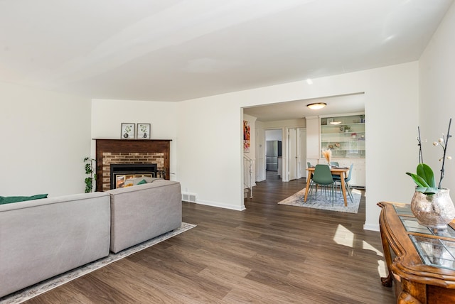 living room featuring wood-type flooring and a fireplace