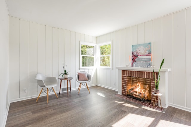 living area with a fireplace and dark hardwood / wood-style flooring