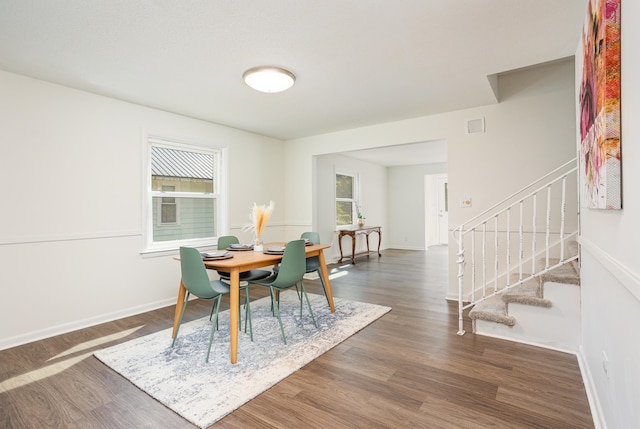 dining area with dark hardwood / wood-style flooring and a wealth of natural light