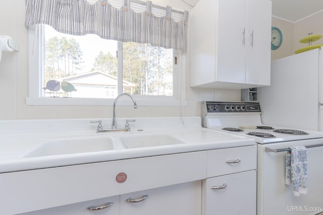 kitchen with white cabinets and electric range