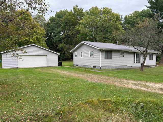 view of property exterior with a lawn, an outbuilding, and a garage