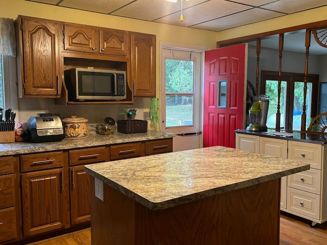 kitchen with light hardwood / wood-style flooring and a center island