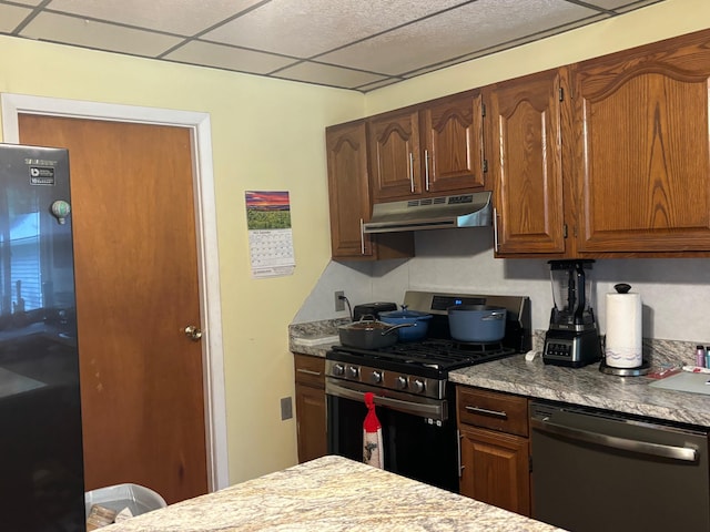 kitchen with a paneled ceiling and stainless steel appliances