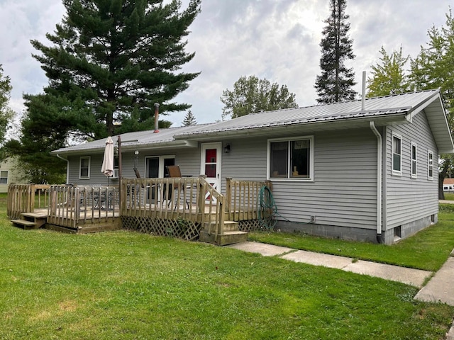 view of front of home featuring a front yard and a deck