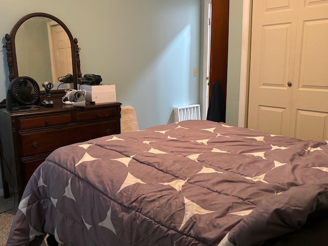 carpeted bedroom with a closet