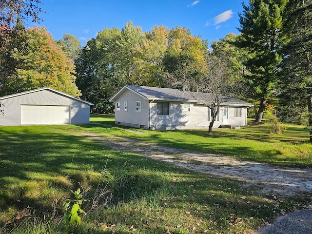 view of side of property with an outbuilding, a garage, and a lawn