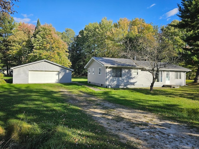 exterior space with a yard, an outbuilding, and a garage