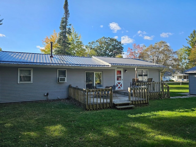 back of house with a yard and a wooden deck