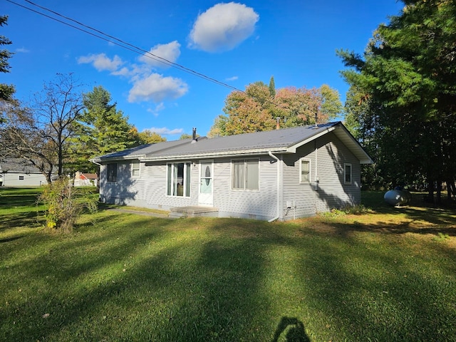 back of property featuring a yard