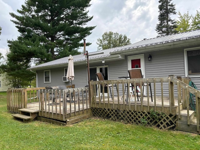 rear view of house with cooling unit, a yard, and a deck