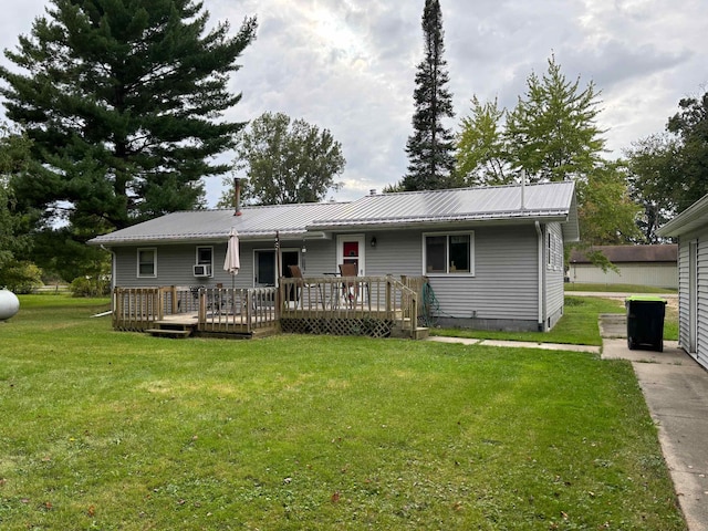 single story home with a front yard and a wooden deck