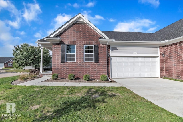 view of front of house with driveway, brick siding, a front lawn, and an attached garage