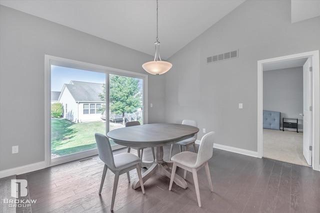 dining space with high vaulted ceiling, baseboards, visible vents, and dark wood-type flooring