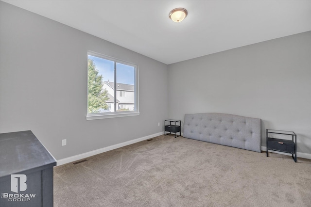 unfurnished bedroom featuring light carpet